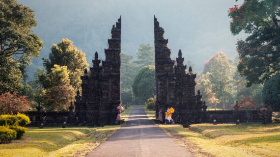 Ancient bali gate with shining pathway in garden